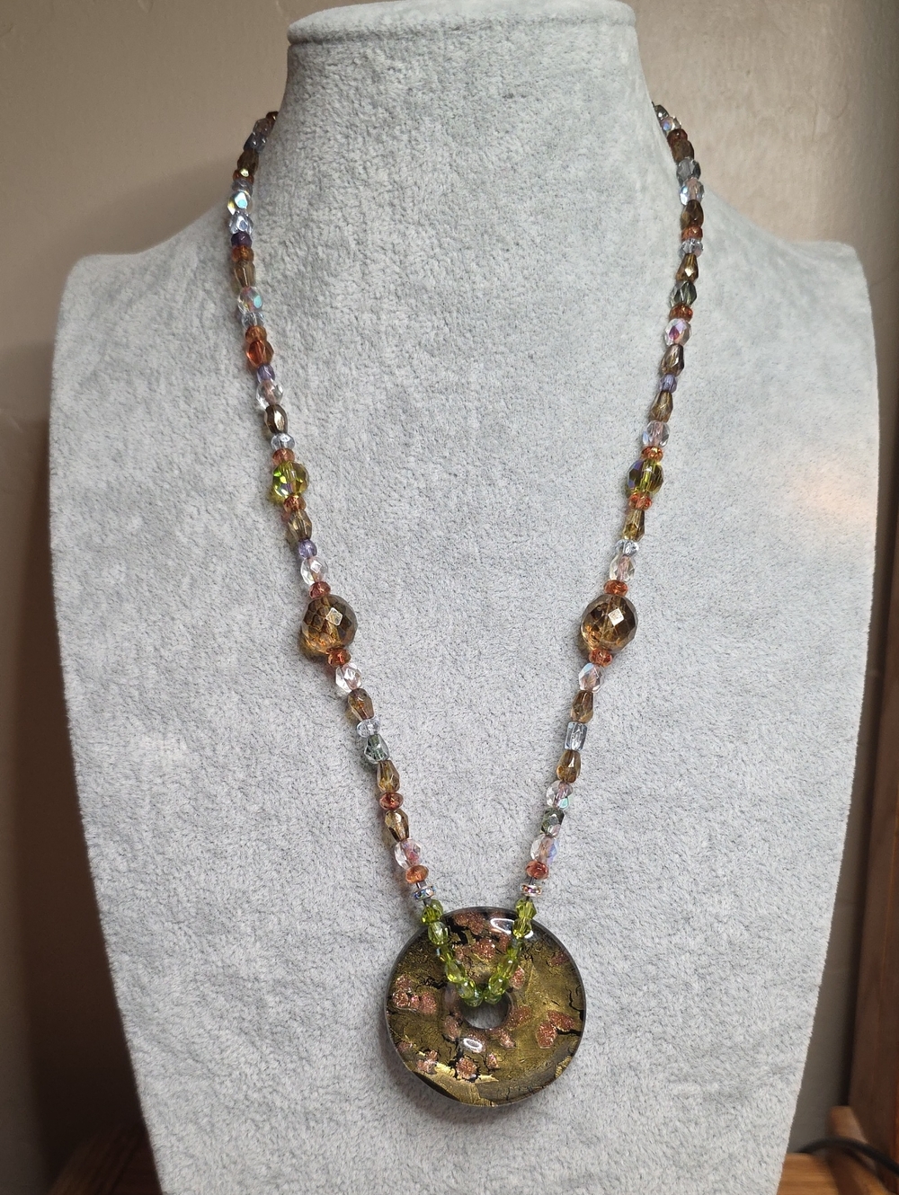 Faceted Glass Beaded Necklace With A Glass Foiled Donut Pendant